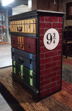 a stack of suitcases sitting on top of a wooden floor next to a red brick wall