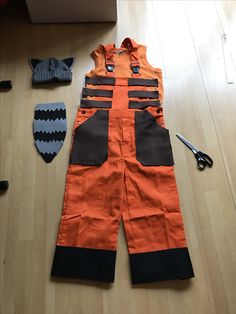 an orange and black construction worker's overalls on the floor