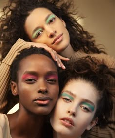 three models with different makeup looks posing for the camera