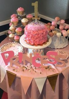 a pink and gold first birthday party with cupcakes