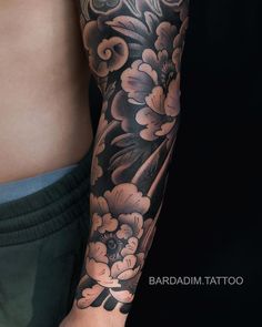 a man's arm with flowers on it