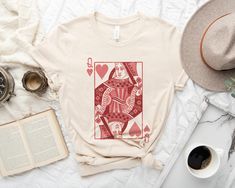 a t - shirt with an ace playing card on it next to a cup of coffee