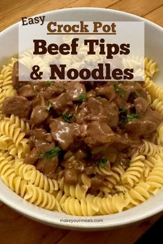 beef tips and noodles in a white bowl on a wooden table with the words easy crock pot beef tips and noodles