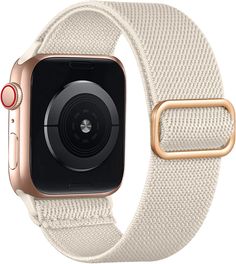 an apple watch with a gold buckle and white fabric band on the front of it