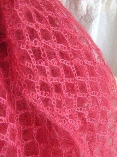 a woman wearing a pink lacy shawl