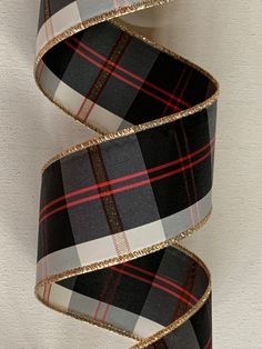 two rolls of black and white plaid ribbon with gold glitters on each one side