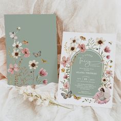 two wedding cards with flowers and butterflies on them, sitting next to the same card