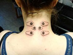 a woman's back neck with three pieces of metal on the top and bottom of her neck