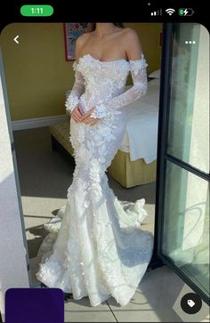 a woman in a white wedding dress posing for the camera