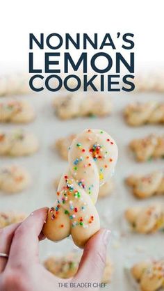 a person holding up some cookies with sprinkles