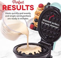 the waffle maker is being poured with peanut butter on top and berries in the background