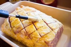 a cake in a pan with a brush on top