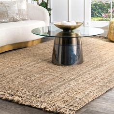 a living room with a couch, coffee table and rug