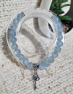 This elegant bracelet features 8mm blue crackle beads, white beads, and silver diamond ring like accents Silver key charm Crackle Beads Bracelet, Silver Diamond Ring, Silver Key, Elegant Bracelet, Beaded Stretch Bracelet, Beads Bracelet, White Beads, Silver Diamonds, Bead Bracelet