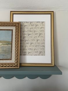 two framed pictures are sitting on a shelf next to each other, one with writing and the other without