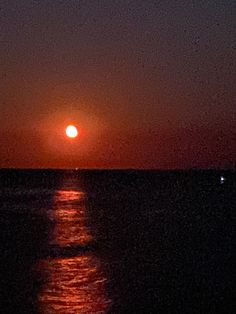 the sun is setting over the ocean as it reflects in the water