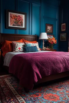 a bedroom with blue walls and red bedding