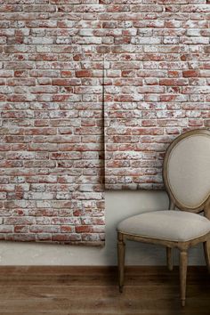 a chair sitting in front of a brick wall