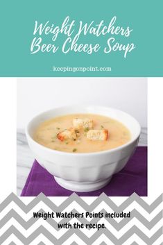 a white bowl filled with soup on top of a purple table cloth