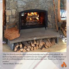 a fire place with logs in it and a basket on the mantle next to it