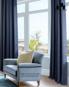 a blue chair sitting in front of a window