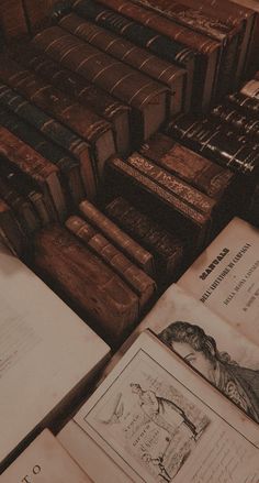 many old books are stacked on top of each other