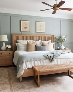 a bedroom with a bed, dressers and ceiling fan in the middle of it