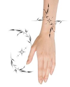 a woman's hand with a small tattoo on the wrist and an arrow in the middle