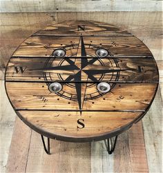 a wooden table that has a compass on it