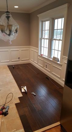 an empty room with hard wood flooring being installed