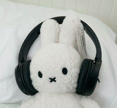 a white stuffed animal with headphones on it's ears