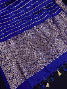 SILK MARK CERTIFIED !!Gorgeous Pure KatanSilk Blue Color with Copper and Slier Zari Work. Strips Sarees in Copper and Sliver Zari with Floral Buttas on the Pallu Soft, light weight and easy to drape Saree. The Strips are dense towards the pallu and get scattered the other end. Item : SareeColor : Blue ColorBase Fabric : Pure Katan Silk Blouse piece : Comes with Blouse pieceBlouse material : Pure Katan SilkFall & Edging (Yes/No) : YesComes with Silk Mark Certificate (Yes/No) : Yes Disclaimer -:- Blue Raw Silk Blouse Piece With Traditional Patterns, Blue Handloom Traditional Wear For Celebration, Blue Katan Silk Traditional Wear For Festive Occasions, Blue Traditional Wear With Zari Weaving For Celebration, Blue Zari Weaving Set For Puja, Blue Handloom Saree For Celebration, Blue Banarasi Silk Set For Puja, Blue Dupatta With Traditional Patterns For Celebration, Blue Art Silk Blouse Piece For Celebration