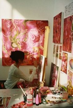 a woman is painting in an art studio