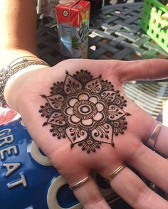 a woman's hand with a henna tattoo on it