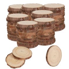 a pile of wood slices next to a stack of cut up tree trunks on a white background