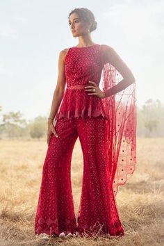 Red peplum kurta with all-over embroidery and cutwork hems. Comes with sharara and dupatta.
Component: 3
Pattern: Embroidered
Type Of Work: Beads and Cutdana
Neckline: Round
Sleeve Type: Sleeveless
Fabric: Tulle
Color: Red
Other Details: 
Embroidered dupatta with cutwork border
Sheer kurta bottom
Note: Bag carried by the model is not for sale
Note: Ivory kurta sharara worn by the model is not for sale
Occasion: Wedding - Aza Fashions Peplum Sharara, Indian Designers, Kurta Sharara Set, Red Kurta, Kurta Sharara, Indian Look, Top Indian, Red Beads, Sharara Set