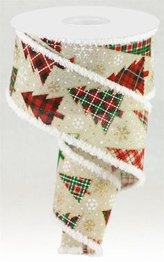 a roll of white and red plaid ribbon with christmas trees on it's side