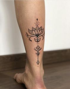 a woman's leg with a flower tattoo on her left calf and an arrow in the middle