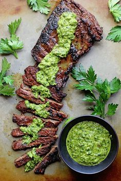 grilled steak with guacamole sauce and parsley on the side for garnish