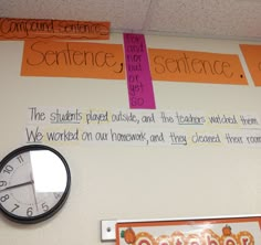 a bulletin board with writing on it and a clock hanging from the wall next to it