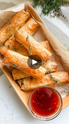 some food is sitting on a plate with ketchup and sauce in front of it