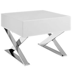 a white table with metal legs and a square shaped design on the top, in front of a white background