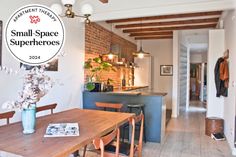 the small space has been converted into a dining room and kitchen area with brick walls