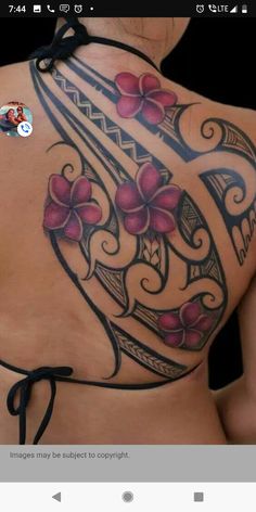 the back of a woman's tattoo with flowers on her chest and an arrow