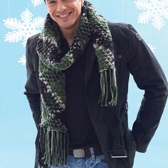 a man standing in front of a snowflake wearing a scarf