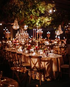 the tables are set with candles and place settings for an elegant dinner or reception at night