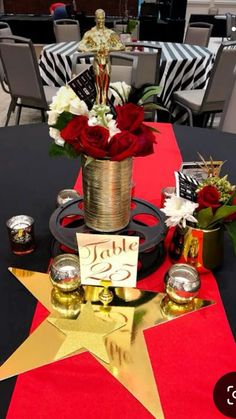 the table is decorated with red roses and gold star for an anniversary party or special occasion