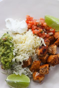 looking down at some chopped chipotle chicken arrange with shredded cheese, chopped tomatoes, sour cream, guacamole and lime wedges. Cholula Chicken, Chipotle Chicken Copycat, Copycat Chipotle Chicken, Chipotle Chicken Marinade, Chipotle Recipes Chicken, Mexican Favorites, Copycat Chipotle, Sugar Diet, Drink Inspiration