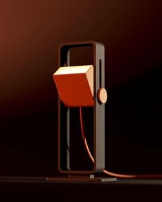 a red and black lamp with a book on it