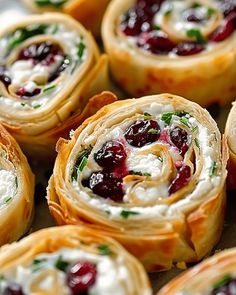 several cranberry rolls with cream cheese and green garnish